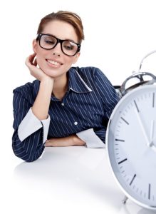 Portrait of responsible woman with watch in the office